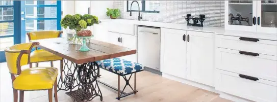  ?? Megan Beierle Shelby Wood Design ?? AN OPEN-SPACE kitchen in Santa Monica features wood from a barn, a table made from a stand for a sewing machine, Ann Sacks tile and white oak plank f loors.