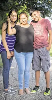  ?? Marie D. De Jesus / Houston Chronicle ?? Patricia Salazar, 40, is working two jobs so she can be home at lunchtime with her children Linneth, 13, left, and Maykol, 14. Patricia Salazar came to the United States from Honduras eight years ago and sent for her children last year.