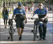  ?? RALPH BARRERA / AMERICAN-STATESMAN ?? University of Texas police patrol the promenade Tuesday on the Gregory Gym Plaza, where four people were stabbed Monday. UT police have stepped up patrols in the wake of the incident.