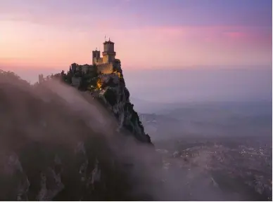  ??  ?? Above
ENCHANTMEN­T San Marino and the incredible castle in the sky as it’s shrouded in soft gentle fog during sunset. there are certain places in the world that are so beautiful they can take your breath away and leave you speechless