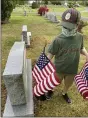  ?? PHOTO COURTESY OF CORY DERER ?? Jacob Derer, 10, of Birdsboro, a member of Cub Pack 595 places flags on veterans’ grave last May. The Boy Scout pack and associated troop, chartered by St. Mark’s Lutheran Church, Birdsboro, found ways to remain active through the COVID-19 pandemic.