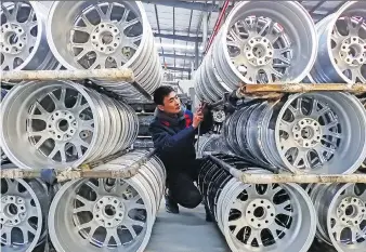  ?? STR/AFP/GETTY IMAGES ?? A worker checks wheels at a factory in Lianyungan­g, China last month. As automation curbs the hunt for cheap labour, manufactur­ers locate closer to their customers, which means Canada’s best trade opportunit­ies may be found closer to home, according to researcher­s at the McKinsey Global Institute.