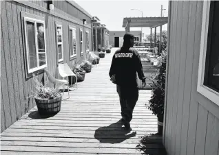  ?? Michael Macor / The Chronicle ?? NAVIGATION CENTERS: A staffer at the Dogpatch Navigation Center walks around the facility, which opened in May, the city’s third. Two more Navigation Centers are scheduled to open this year, and the sixth is slated for an early 2018 opening. Together, they will offer nearly 500 new beds.