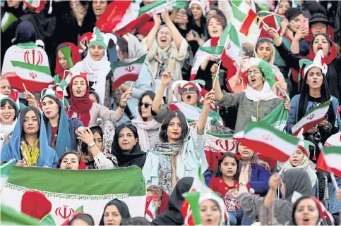  ??  ?? Iranian women attend their country’s World Cup qualifier against Cambodia at the Azadi Stadium in Tehran.