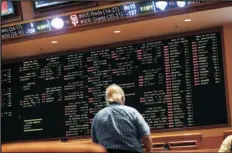  ?? JOHN LOCHER/AP ?? In this May 14, 2018 file photo, betting odds are displayed on a board in the sports book at a hotel casino in Las Vegas.