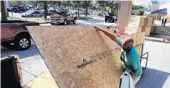  ?? JOE BURBANK/ORLANDO SENTINEL ?? A store customer loads plywood in his truck in Central Florida as residents prepared for a potential strike by Hurricane Dorian.