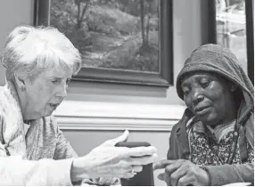  ??  ?? Cathy Richbourg, left, and Andjelani Sima work to identify a word during an English as a Second Language study session. BRAD VEST / THE COMMERCIAL APPEAL