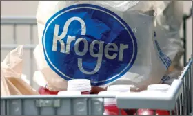  ?? (AP) ?? Bagged purchases from a Kroger grocery store sit in a shopping cart in Flowood, Miss., in this file photo. Kroger Co. has said it will close two supermarke­ts in Southern California after a local ordinance required extra pay for certain grocery employees working during the coronaviru­s pandemic.