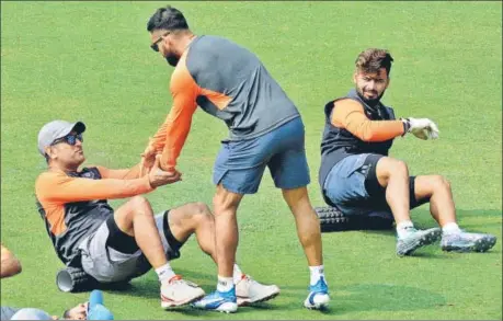  ?? PTI ?? Rishabh Pant looks on as Virat Kohli gives MS Dhoni a helping hand during a practice session at the ACA Stadium, Barsapara, Guwahati on Saturday.