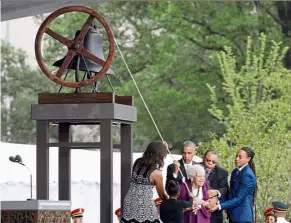  ??  ?? For whom the bell tolls: Barack and Michelle Obama (left), joining Bonner (centre) and her family in ringing a bell to mark the opening of the Smithsonia­n’s National Museum of African-American History and Culture in Washington. — Bloomberg