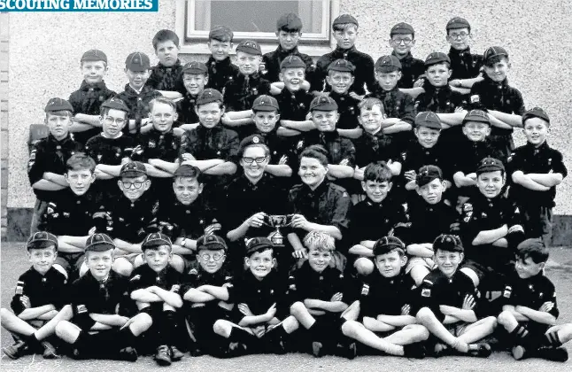  ??  ?? Wolf winners Local Scouting legend Ina Shaw MBE is inviting readers to take a walk down memory lane with this photo which is of her St Ninians Wolf Cubs with the Sports Cup they won in 1963. Mrs Shaw is seen holding the trophy with fellow leader Helen...