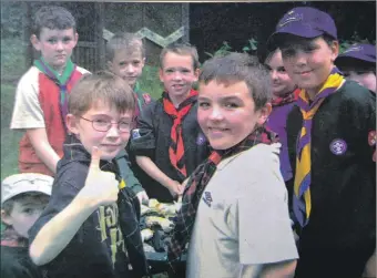  ?? ?? 2003: Beaver and Cub Scouts from all areas of Argyll gathered in the grounds of Kilmory Castle, Lochgilphe­ad, on Saturday for a day of fun and challenges. These cubs stopped to have their picture taken while making twists, from a mixture of flour and water, over the campfire.