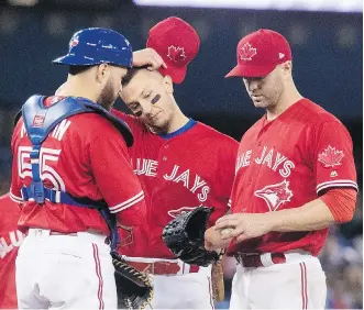  ?? FRED THORNHILL/THE CANADIAN PRESS/FILES ?? Russell Martin, Troy Tulowitzki and J.A. Happ, left to right, are all on the Blue Jays’ disabled list. Toronto has US$90 million worth of salary on the DL — an amount that exceeds the payroll of the 25-man rosters of 11 major league clubs.