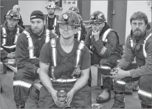  ?? SHARON MONTGOMERY-DUPE/CAPE BRETON POST ?? Ray Berthiaume, in front, of Dominion, listens during a pre-shift safety meeting at the Donkin mine Tuesday.