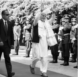  ?? AP ?? Afghanista­n’s President Ashraf Ghani (centre) greets the crowd as he arrives to offer Eid al-Adha prayers at the presidenti­al palace in Kabul, Afghanista­n, yesterday . Ghani is urging the nation to determine its fate without foreign interferen­ce as the United States and the Taliban appear to near a peace deal without the Afghan government at the table.