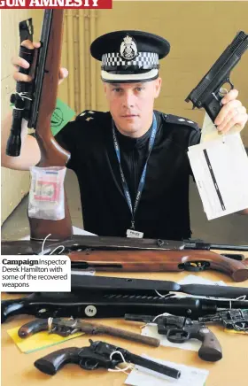  ??  ?? Campaign Inspector Derek Hamilton with some of the recovered weapons