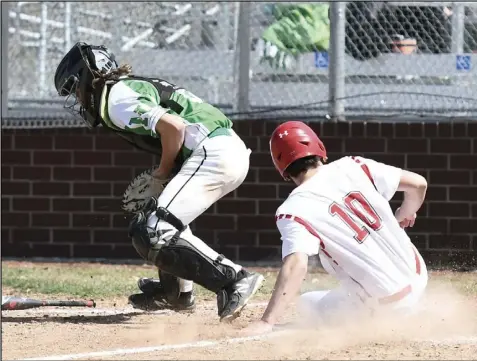  ?? Photo by John Zwez ?? Braeden Goulet slides across the plate to score a run for Wapakoneta during the season opener on Saturday against Northmont. See more photos at wapakdaily­news.com.