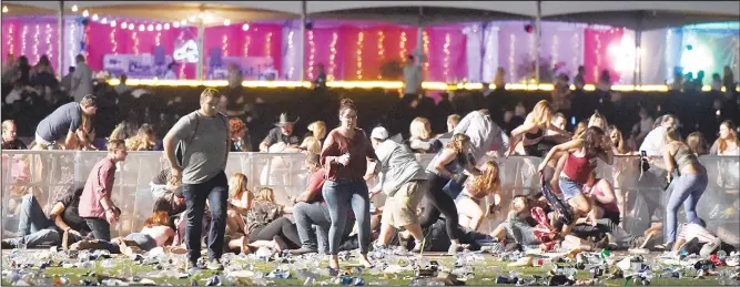  ?? (AFP) ?? People run from the Route 91 Harvest country music festival after gunfire was heard on Oct 1, in Las Vegas, Nevada. There were reports of an active shooter around the Mandalay Bay Resort and Casino.