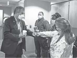  ?? ROBERT MCGRAW/CHILLICOTH­E GAZETTE ?? U.S. Sen. Sherrod Brown fist bumps VA employee Elizabeth Bellman as he talks with her and fellow employees Tiffany Justice, Eric Reed, David Sparks and Courtney Shea during a visit at the Chillicoth­e VA Medical Center on Wednesday.