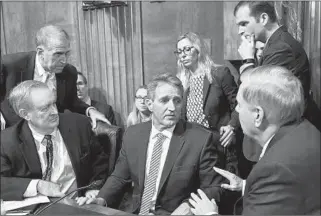  ?? BRENDAN SMIALOWSKI/GETTY-AFP ?? Senate Judiciary Committee member Jeff Flake, R-Ariz., center, consults colleagues after Friday’s hearing.