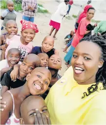  ?? Picture: SUPPLIED ?? CARING: Noluvuyo Zintle Mehlomakhu­lu, dubbed Etipini ‘s Mother Teresa, with some of the children she assists.