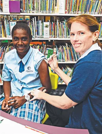  ?? PREVENTIVE ACTION: Grade 10 Calvary Christian College student Sain Moini, 17, gets a meningococ­cal vaccinatio­n from nurse Julie Boxsell. Picture: ZAK SIMMONDS ??