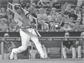  ?? JASEN VINLOVE/USA TODAY SPORTS ?? Marlins outfielder Giancarlo Stanton connects for a two-run home run — his 50th homer of the season — against the Padres on Sunday in Miami.