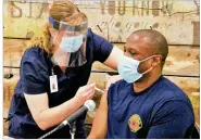  ?? HASAN KARIM/ STAFF ?? First responders in Clark County, like Springfifi­eld fifirefifi­ghter Chris Chilton, are receiving the coronaviru­s vaccine, and Gov. Mike DeWine is still encouragin­g everyone to dowhat they can to save lives during the pandemic.