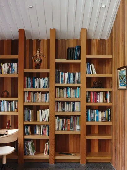  ??  ?? Right Cedar panelling and oak shelving create texture in the study. The pounamu toki on lower shelf was carved by Te Kaha. The ‘Uncino MC 9’ chair by Ronan &amp; Erwan Bouroullec for Mattiazzi is from Simon James Design. ‘Fishing Sheds, Newfoundla­nd’ by Tom Esplin hangs on the wall.