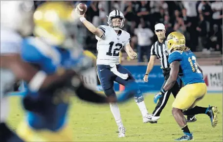  ?? Luis Sinco
Los Angeles Times ?? BRIGHAM YOUNG’S Tanner Mangum is pressured in a road loss to UCLA. The independen­t Cougars are playing a tough schedule.