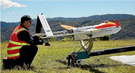  ??  ?? A drone is prepared for launch during a trial flight inspecting Transpower’s transmissi­on lines in the Rimutaka Ranges near Wellington.