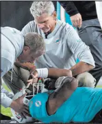  ?? The Associated Press ?? Jeff Dean
The Dolphins’ medical staff tends to quarterbac­k Tua Tagovailoa in the second quarter of Miami’s loss at Cincinnati on Thursday.