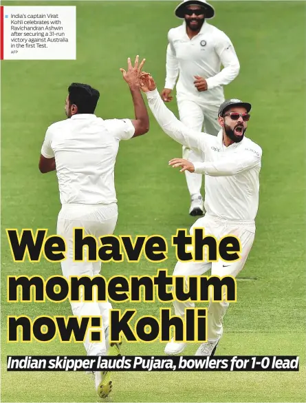  ?? AFP ?? India’s captain Virat Kohli celebrates with Ravichandr­an Ashwin after securing a 31-run victory against Australia in the first Test.