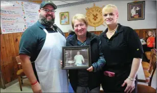  ?? Ernest A. Brown photo ?? Corey Dumas, chef and owner of Lil and Gene’s Family Restaurant, in Manville, left, stands in the dining room with his mother Patsy, holding a picture of Lil Dumas, founder with her husband Gene of the restaurant, and Corey’s sister, Melanie Mendall, a longtime waitress.