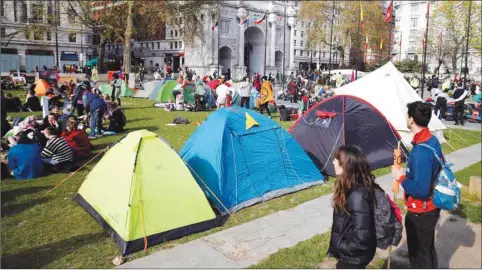  ??  ?? Environmen­tal activists erect tents near Marble Arch during a demonstrat­ion by the Extinction Rebellion group in London yesterday.