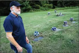  ?? JOHN MINCHILLO / AP ?? Eddie Davis stands beside the gravestone of his son Jeremy (farthest left), who died from the abuse of opioids, on July 17 in Coalton. Members of his family are buried in adjacent plots, including his parents and a sibling.