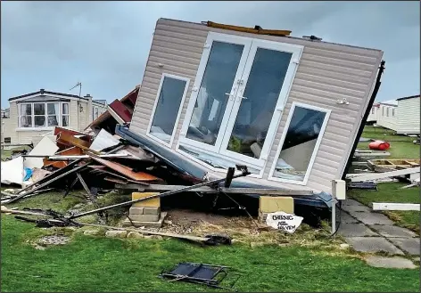  ?? ?? FLIPPED OVER: Holiday homes destroyed at an evacuated caravan park in Hartlepool. Left: A cyclist braves the snow in Sheffield