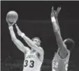  ?? AP FILE ?? In this March 12, 1980, photo, Los Angeles Lakers’ Kareem AbdulJabba­r (33) hooks a shot over Portland’s Jim Brewer (52) during the first half of an NBA game in Los Angeles. Abdul-Jabbar, No. 1 draft pick, has the record for most career points in the NBA.