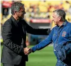  ?? GETTY IMAGES ?? Mark Rudan, left, and Ernie Merrick in a respectful exchange before the Phoenix-Jets match.