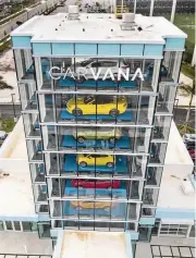  ?? PEDRO PORTAL pportal@miamiheral­d.com ?? After purchasing a car on its website, a Carvana buyer is given a coin to drop into a slot at 2150 NW 117th Place.