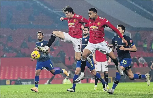  ?? PHOTO: REUTERS ?? Dynamic duo . . . Manchester United defender Victor Lindelof (left) and forward Mason Greenwood in action against Southampto­n in their English Premier League clash at Old Trafford yesterday. United won 90.