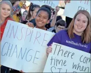  ??  ?? Above: “Inspire Change” was the theme Heritage High School students chose for their March 14 school safety walkout. Right: More than 1,800 Catoosa County students participat­ed in the nationwide March 14 school walkout day, including 200 from Heritage...