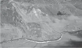  ?? AP ?? A massive landslide along California’s coastal Highway 1 that has buried the road under a 40-foot layer of rock and dirt is seen in this aerial photo on Monday.