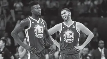  ?? XIA YIFANG/TRIBUNE NEWS SERVICE ?? Golden State Warriors' Jordan Bell, left, and Georges Niang react after the NBA preseason basketball game between the Warriors and Minnesota Timberwolv­es in Shenzhen City of south China's Guangdong Province on Oct. 5.