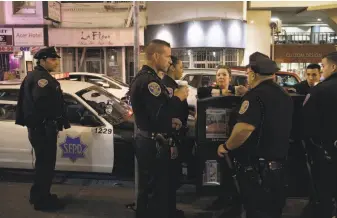  ?? Photos by Nick Otto / Special to The Chronicle ?? Officers at Tenderloin Station chipped in to pay for a hotel room after finding a mother and toddler camping on a Larkin Street corner, and shelters offered no assistance.