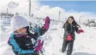  ?? JAMES QUIGG/ USA TODAY NETWORK ?? Ellie and Diana Ochoa of L. A. play in snow while waiting for Highway 138 in Phelan, Calif., to reopen Saturday.