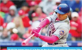  ??  ?? PHILADELPH­IA: Asdrubal Cabrera #13 of the New York Mets hits an RBI double against the Philadelph­ia Phillies in the seventh inning of a game at Citizens Bank Park on Sunday in Philadelph­ia, Pennsylvan­ia. — AFP