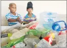  ?? Picture: FREDLIN ADRIAAN ?? CASHING IN: Delton Saffier, 11, left, and Nello Witbooi, 9, bring trash to the Uitenhage Mula Swop Shop