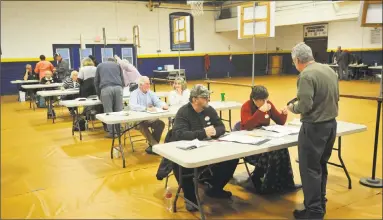  ?? Ben Lambert / Hearst Connecticu­t Media ?? Torrington residents prepare to cast their votes in the municipal elections on Tuesday.