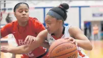  ?? STEVE JOHNSTON/DAILY SOUTHTOWN ?? Marist’s Kira Chivers, right, tries to drive past Homewood-Flossmoor’s Imani Mitchell during a game on last .